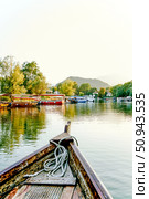Skadar lake, Montenegro, 12 August 2024, Wooden boat yacht sailing on water. Редакционное фото, фотограф Spirit River / Фотобанк Лори