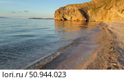 Video of beautiful Baikal Lake at sunset. Olkhon Island. Deserted sandy beach with steep cliffs along shore of Small Sea with pure transparent water in July evening. Natural background. Стоковое видео, видеограф Виктория Катьянова / Фотобанк Лори