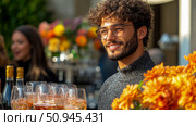 Event Portrait of a Smiling Young Man with Curly Hair, Attending a Social Gathering Featuring Drinks and Flowers. Стоковое AI-изображение, AI-художник Данила Большаков / Фотобанк Лори