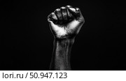 A monochrome arm with a clenched fist raised in defiance. Стоковое AI-изображение, AI-художник Данила Большаков / Фотобанк Лори
