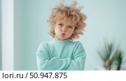 Adorable Child's Expressive Portrait: A young boy with tousled hair, arms crossed, and a pout showing emotion and charm, ready for children's related content. Стоковое AI-изображение, AI-художник Данила Большаков / Фотобанк Лори