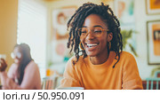 A radiant Black woman with dreadlocks and elegant spectacles sharing a genuine, joyful laugh in a brightly lit, inviting indoor setting, capturing an authentic moment of happiness. Стоковое AI-изображение, AI-художник Данила Большаков / Фотобанк Лори