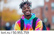 Portrait of a Young Smiling Student with Colorful Hoodie and Backpack. Стоковое AI-изображение, AI-художник Данила Большаков / Фотобанк Лори