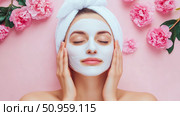 A serene woman enjoying a purifying face mask treatment with pink peonies, symbolizing beauty and self-care for spa content. Стоковое AI-изображение, AI-художник Данила Большаков / Фотобанк Лори