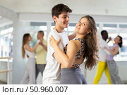 Young woman dances incendiary tango with man partner during choreography lesson. Стоковое фото, фотограф Яков Филимонов / Фотобанк Лори