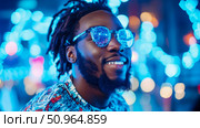 Cyberpunk Portrait: African American man with futuristic glasses in a vibrant, neon-lit setting. Стоковое AI-изображение, AI-художник Данила Большаков / Фотобанк Лори