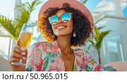 A joyful woman enjoying a bright day, wearing a pink hat and mirrored sunglasses, holding a sparkling drink glass in a tropical outdoor setting, ideal for a summer vacation advertisement. Стоковое AI-изображение, AI-художник Данила Большаков / Фотобанк Лори