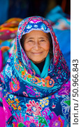 Authentic portrait of an elderly woman with a radiant smile, draped in incredibly vibrant, traditional patterned textiles, conveying wisdom and cultural heritage for wall art. Стоковое AI-изображение, AI-художник Данила Большаков / Фотобанк Лори