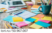 A vibrant and bustling workspace featuring a journal, colorful sticky notes, and assorted pens, symbolizing productive work and creative planning. Стоковое AI-изображение, AI-художник Данила Большаков / Фотобанк Лори