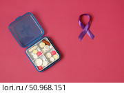Daily medication intake and purple ribbon symbolizing awareness for several diseases and medical conditions. Стоковое фото, фотограф Дмитрий Цветков / Фотобанк Лори