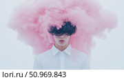 A captivating portrait of a young person shrouded in a voluminous cloud of ethereal pink smoke, their eyes hidden by dark hair, creating a profound and artistic visual narrative. Стоковое AI-изображение, AI-художник Данила Большаков / Фотобанк Лори