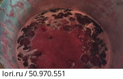 Homemade preparation of strawberry jam. Foam and juice when cooking strawberries. The process of making strawberry jam. Close-up of boiling strawberries. Стоковое видео, видеограф Андрей Жигальцов / Фотобанк Лори