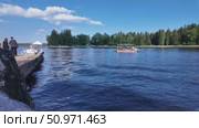 Boating and relaxation on a sunny day on the shore of the Vyborg Bay against the backdrop of green trees - Vyborg, Russia, July 15, 2025. Редакционное видео, видеограф Наталия Попова / Фотобанк Лори