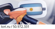 The flag of Argentina on the hatch of the gas tank of the car at the gas station. Refueling pump for Gasoline and diesel fuel in Argentina. High prices for diesel fuel, gasoline and gas at gas stations in Buenos Aires, the quality of gasoline fuel. Стоковое фото, фотограф Владимир Разгуляев / Фотобанк Лори