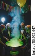 Enchanting gathering of people around a bubbling cauldron with eerie face paint, festive decorations, and spooky atmosphere. Стоковое AI-видео, аниматор Данила Большаков / Фотобанк Лори