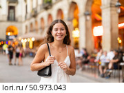 In evening, young smiling girl walks along city street Placa Real. Стоковое фото, фотограф Яков Филимонов / Фотобанк Лори