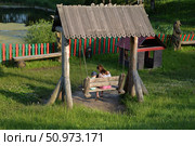 Kirzhach, Vladimir Region, Russia, June 17, 2025:  Mother with son on swings at playground near pond in summer on Gagarin Street. Редакционное фото, фотограф Алексей Антипов / Фотобанк Лори