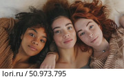 A heartwarming depiction of three youthful females with varied complexions and vibrant hair, sharing an intimate moment of genuine connection. Стоковое AI-видео, аниматор Данила Большаков / Фотобанк Лори