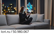 Woman interacting with futuristic holographic interface at night in urban apartment. Стоковое AI-видео, аниматор Владимир Федоров / Фотобанк Лори