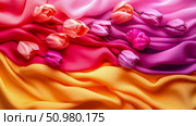 Tulips on Colorful Draped Fabric: A Springtime Still Life. Стоковое AI-изображение, AI-художник Данила Большаков / Фотобанк Лори
