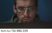 A male IT specialist in glasses, coding late at night. Стоковое видео, видеограф Arsenii Palivoda / Фотобанк Лори