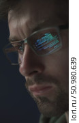 Close-up of programmer with code reflection in glasses. Стоковое видео, видеограф Arsenii Palivoda / Фотобанк Лори