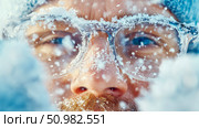 Close-up of a man's face covered in snowflakes, wearing glasses. Стоковое AI-изображение, AI-художник Данила Большаков / Фотобанк Лори