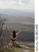 Mountains freedom woman: Person celebrates view atop mountain during daytime hike, feeling liberated. Стоковое фото, фотограф svetograph / Фотобанк Лори