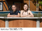 Two teenage sisters swimming in the pool. Стоковое фото, фотограф Андрей Аркуша / Фотобанк Лори