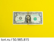 Dollar on a yellow background, background with copy space. Стоковое фото, фотограф Юлия Николаева / Фотобанк Лори