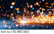 Celebratory spectacle of brilliant fiery sparks scattering over shiny ground, adorned with dreamy array of blurred, glowing light orbs. Стоковое AI-изображение, AI-художник Данила Большаков / Фотобанк Лори