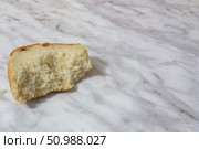Bitten piece of old white bread on the table. Стоковое фото, фотограф Коханова Наталья / Фотобанк Лори