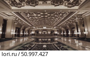 Luxurious hotel lobby with gleaming marble flooring, tranquil reflecting pool, and elaborate ceiling highlighting elegant, high end interior design elements. Стоковое AI-видео, аниматор Данил Руденко / Фотобанк Лори
