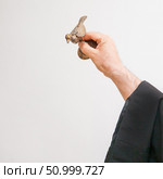 An Armenian priest holds a bird figurine in his hand and performs the rite of baptism over the font. Стоковое фото, фотограф Екатерина Красникова / Фотобанк Лори