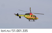 Medical helicopter, bearing team of rescuers, descends swiftly during critical situation, while group of onlookers gathers on ground below. Стоковое видео, видеограф Strunov David / Фотобанк Лори