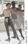 Men and women stand in second position near ballet barre during group training in a dance studio. Стоковое видео, видеограф Яков Филимонов / Фотобанк Лори