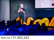 Speaker engaging audience during a modern presentation in a vibrant venue. Стоковое фото, фотограф Антон Гвоздиков / Фотобанк Лори