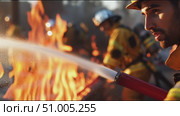 Firefighters combat wildfires in dry forest during golden hour with intense flames in the background. Стоковое AI-видео, аниматор Сергей Толмачёв / Фотобанк Лори