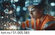 Young woman working with welding equipment in industrial setting at night. Стоковое AI-видео, аниматор Сергей Толмачёв / Фотобанк Лори