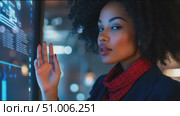 Young professional analyzes data trends on a digital interface in a modern office setting at night. Стоковое AI-видео, аниматор Сергей Толмачёв / Фотобанк Лори