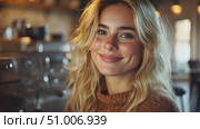 A friendly barista with long hair smiles warmly while standing next to a coffee machine in a welcoming café setting. Стоковое AI-видео, аниматор Данила Большаков / Фотобанк Лори