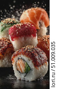 Assorted sushi rolls with sesame and roe in dramatic fiery background scene. Стоковое AI-видео, аниматор Александра Рублева / Фотобанк Лори
