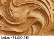Creamy peanut butter spread swirl surface. Closeup, full frame. Crunchy Peanut butter background. American cuisine traditional product. Appetizing textured smears. Food paste from ground roasted nuts. Стоковое AI-изображение, AI-художник Марина Демидюк / Фотобанк Лори