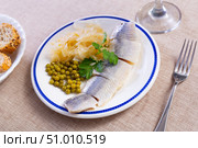 Slices of lightly salted herring filets with pickled cabbage, peas, greens. Стоковое фото, фотограф Яков Филимонов / Фотобанк Лори