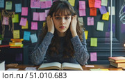 A young woman struggles to concentrate while studying, surrounded by colorful sticky notes and books in a cozy workspace at night. Стоковое AI-видео, аниматор Данила Большаков / Фотобанк Лори