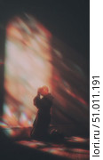 Person in silhouette in a dimly lit room contemplating inner thoughts with colorful light reflections. Стоковое AI-видео, аниматор Сергей Толмачёв / Фотобанк Лори