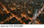 Bustling cityscape from above after dark. Lights illuminate streets, buildings, and highways creating a vibrant urban nightscape. Стоковое AI-видео, аниматор Данила Большаков / Фотобанк Лори