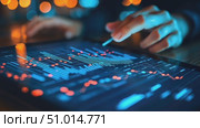 A person analyzes complex data visualizations on a tablet while surrounded by soft lighting in the background. Стоковое AI-видео, аниматор Данила Большаков / Фотобанк Лори