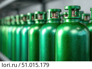 Green oxygen tanks. Bundle of gas cylinder and high pressure gauges, meter, valve. Many argon cylinders with compressed gas for industry, welding. Fuel manufacturing. Liquefied gas production, factory. Стоковое AI-изображение, AI-художник Марина Демидюк / Фотобанк Лори