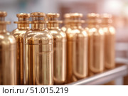 Brass oxygen tanks. Bundle of gas cylinder and high pressure gauges, meter, valve. Many argon cylinders with compressed gas for industry, welding. Fuel manufacturing. Liquefied gas production, factory. Стоковое AI-изображение, AI-художник Марина Демидюк / Фотобанк Лори